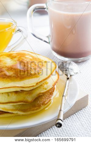 Glass Mug With Cocoa, Silver Spoon, Honey And Pancakes