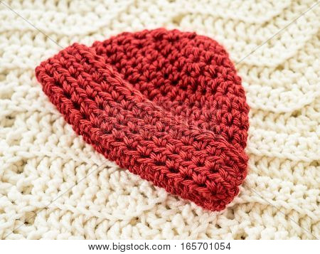 Preemie-sized crocheted red hat with fold-up brim