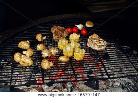 Vegetables And Meat Grilling. Mushrooms Corn Pepper Tomatos Garlic On Grill. Catering In Food Court