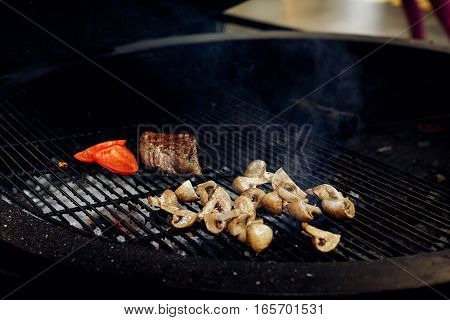 Vegetables And Meat Grilling.  Beefsteak Mushrooms  Tomatos Garlic On Grill. Catering In Food Court