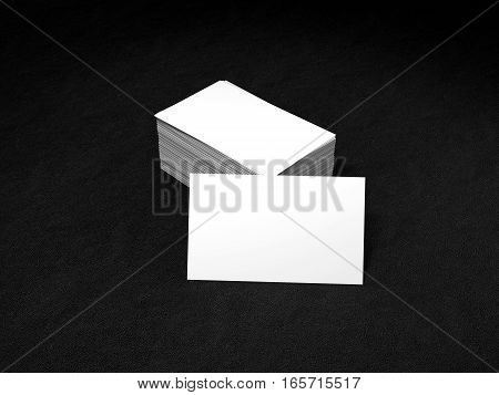 Stack of white business cards. Name cards mockup template on black leather background. 3D Rendering with shadow