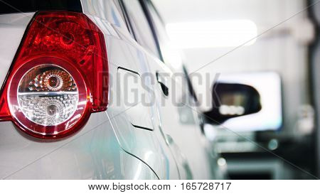 Auto service - red backlights of white car, transportation concept, close up