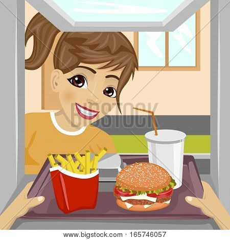 hands giving a tray with fast food meals through a drive-thru window to happy teenager girl