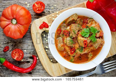 Meat goulash pork stew with red bell pepper and tomatoes gravy sauce
