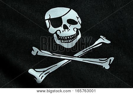 fabric texture of the pirate flag waving in wind calico jack pirate symbol hacker and robber concept