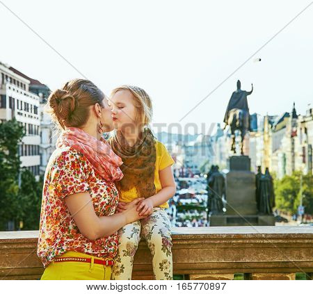 Smiling Mother And Daughter Tourists In Prague Kissing
