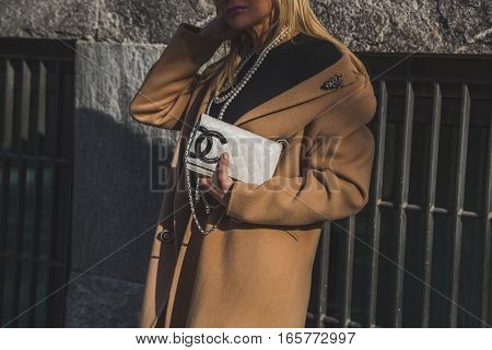 MILAN ITALY - JANUARY 17: Fashionable woman poses outside Armani fashion show building during Milan Men's Fashion Week on JANUARY 17 2017 in Milan.