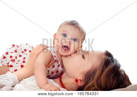 Portrait of mother and baby playing and smiling at home.