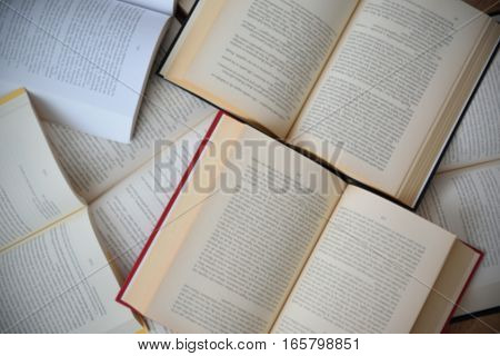 Some open books background. Messy table in a library.