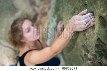 Young Woman Climbing On Large Boulders Outdoor