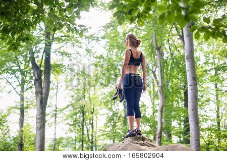 Woman Standing On The Top Of Rock After Climbing Boulder