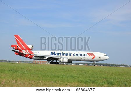 May11th 2015 Schiphol Airport the Netherlands: PH-MCU Martinair Holland McDonnell Douglas MD-11 on Polderbaan runway. Martin Air is based in Amsterdam and was founded in 1958 Since 2014 Martinair operates primarily as a cargo airline.