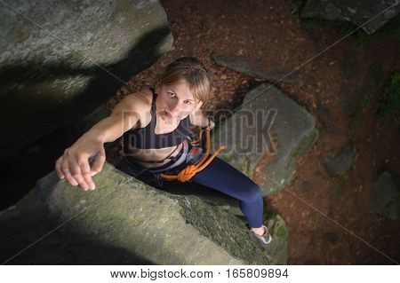 Female Climber Climbing With Rope On A Rocky Wall