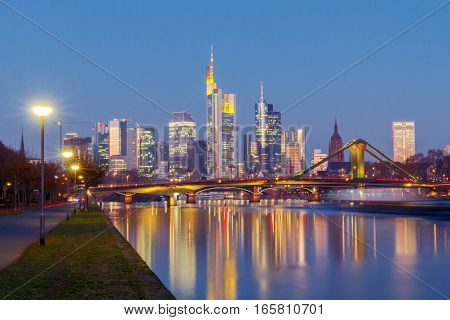 Picturesque views of the city's waterfront and skyscrapers at night in Frankfurt. Germany.