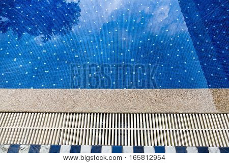 Hotel swimming pool with sunny reflections Swimming pool of luxury hotel Swimming pool and stoone deck ideal for backgrounds
