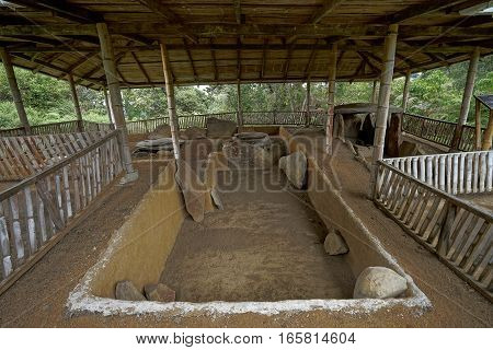 ancient pre-columbian tomb in San Agustin Colombia with statue in ALtos de los Idolos San Agustin Colombia