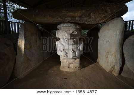ancient pre-columbian tomb in San Agustin Colombia with statue in ALtos de los Idolos San Agustin Colombia
