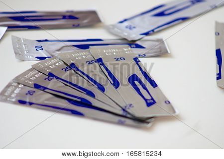 several pieces of packaged sterile blade to the scalpel for medical purposes