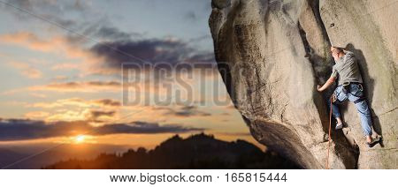 Male Climber Climbing Big Boulder In Nature With Rope