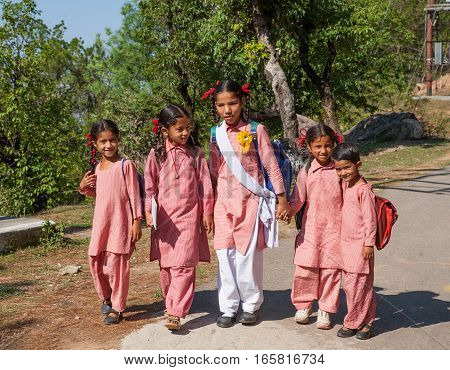 DHARAMSALA, INDIA. 2 Jun 2009: Daily lifestyle. Students  go to lessons on a mountain road in the Himalayas. Western Himalayas, Himachal Pradesh, district of Kangra.