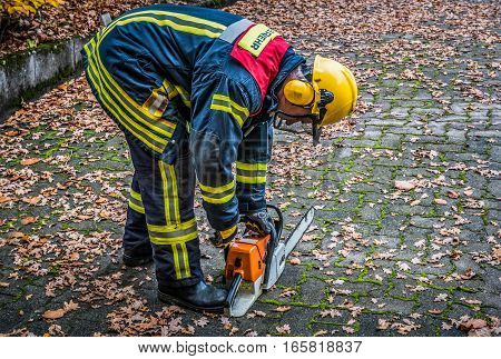 HDR - firefighter in action with a chainsaw