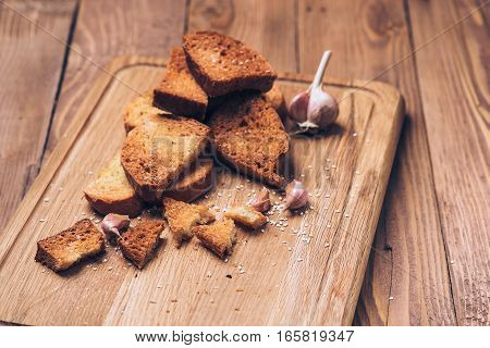 Bread crumbs spices and garlic on the wooden background.