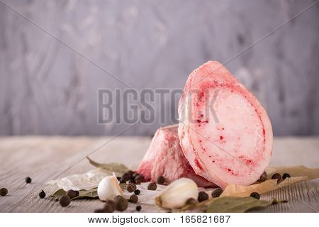 Two Marrowbone Pieces With Spice On Light Wooden Board