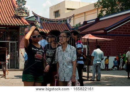 Penang, Malaysia, July 2015 - Family in front of temple, grandmother, mother daughter