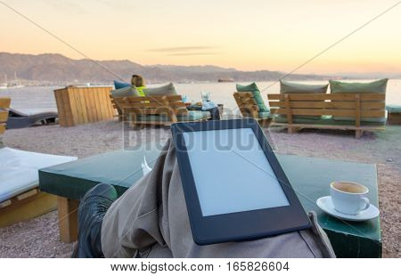 Enjoying An E-book E-reader On The Beach