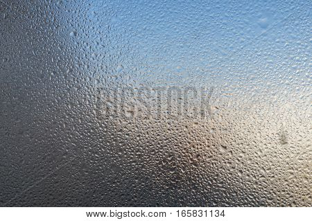 Closeup detail of Moisture condensation problems, hot water vapor condensed on the cold window glass, macro