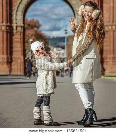 Mother And Child Near Arc De Triomf In Barcelona Handwaving