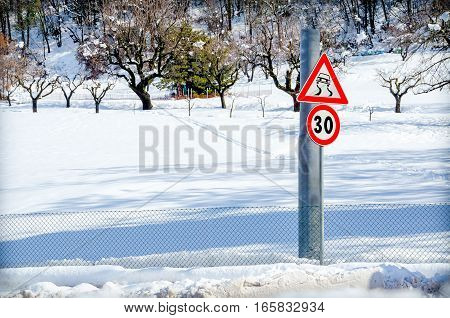 danger road sign snow winter path country road