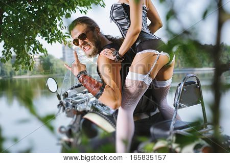 Portrait Of Sexy Couple Of Bikers On The Motorcycle