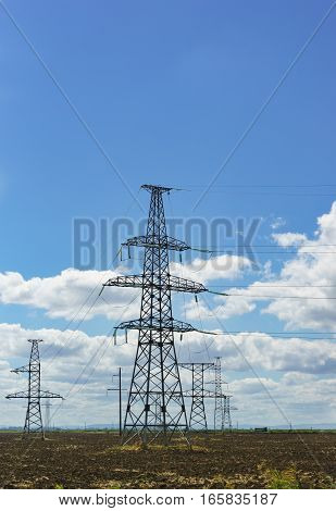 Power lines against the sky with clouds