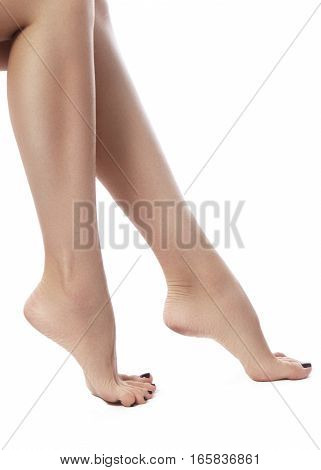 Beautiful female legs after depilation. Healthcare foot care rutine treatment. Spa and epilation. Sexy shape of woman's body. Part of female body. Feet with perfect clean smooth skin and pedicure.