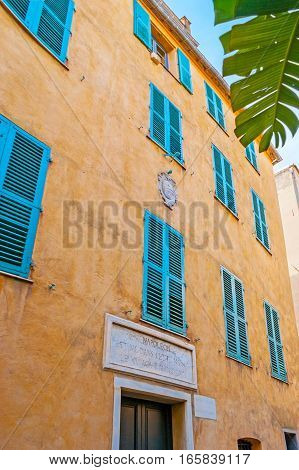 AJACCIO FRANCE - MAY 2 2013: The Maison Bonaparte is the Napoleon's birth house with the small stone sign board above the entrance located in St Charles street on May 2 in Ajaccio.
