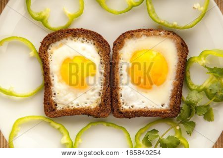 Healthy breakfast with toasted bread and eggs with cup of tea and milk. Fast snack with yolk and coffee.