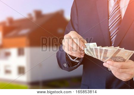 Polish Businessman Holds Money. The Loan On The House