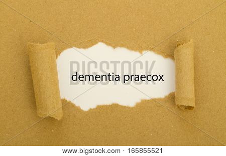 dementia praecox word written under torn paper.