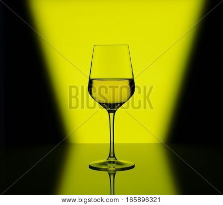 Wineglass with white wine on blurred multicolored background
