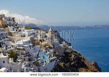 Fira, modern capital of the Greek Aegean island, Santorini, with orthodox church, caldera and volcano, Greece