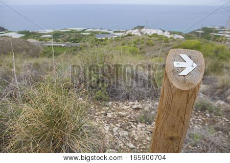Hiking sign at trekking path over Nerja Caves Mountain. Overlooking Town of Nerja Malaga Spain