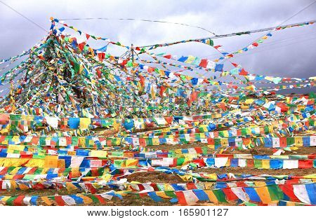   Coloful prayer flag in top of snow mountain at Deqin Yunnan China