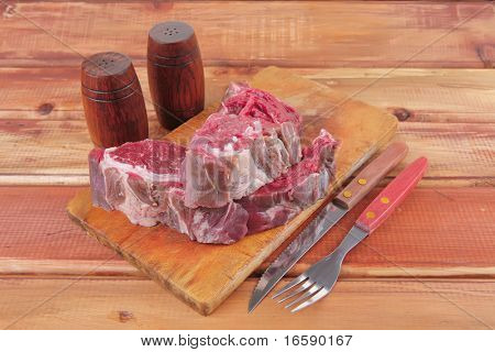 savory: uncooked raw bloody beef meat steak before cooking on wood