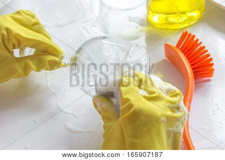 concept of woman washing dishes on white background with hands