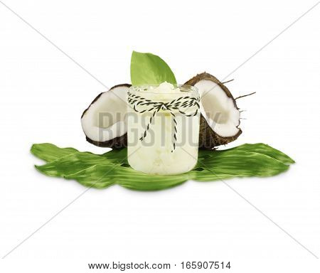 Jar of coconut oil and fresh coconuts isolated on white background. Coconut nuts with leaves.