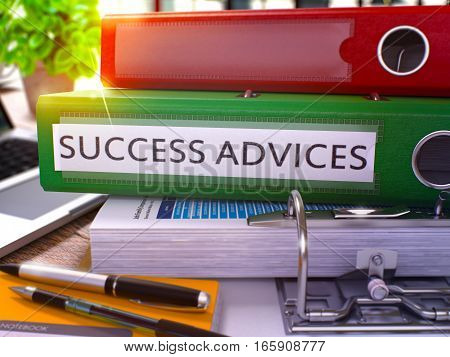 Green Ring Binder with Inscription Success Advices on Background of Working Table with Office Supplies and Laptop. Success Advices Business Concept on Blurred Background. 3D Rendering.