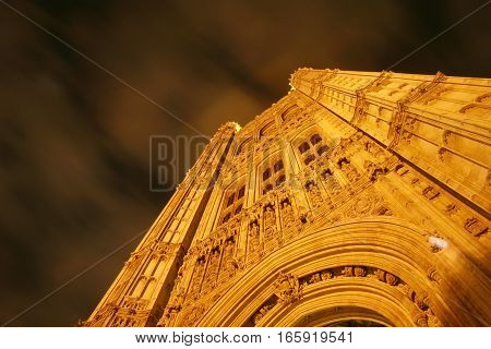 Low angle, night view looking up at the Victoria Tower, the tallest point of the Houses of Parliament, London, UK.