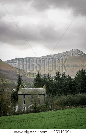 A Welsh farm house nestling in a valley deep in the Brecon Beacons, Wales, UK.