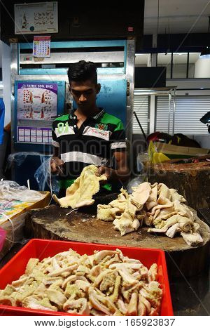 Unidentified Indian Butcher Sits At His Butcher Shop